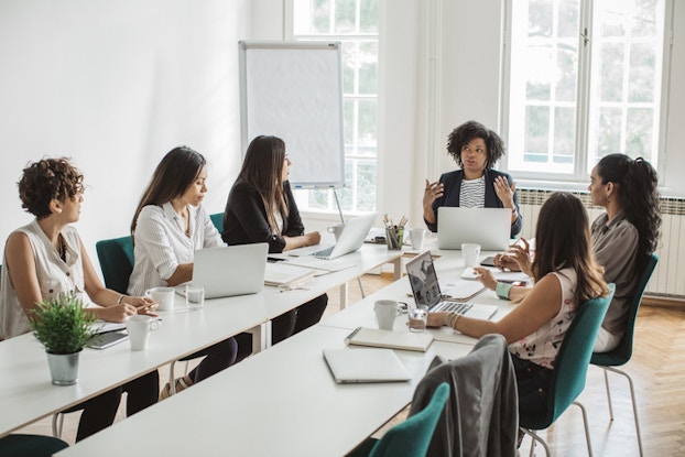  female employees in a business meeting