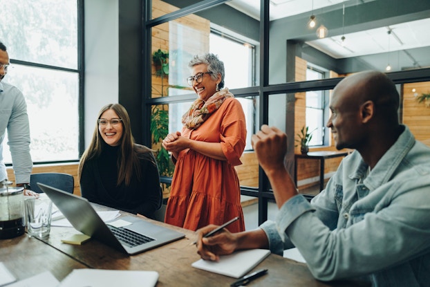  Group of happy employees smiling during a meeting.