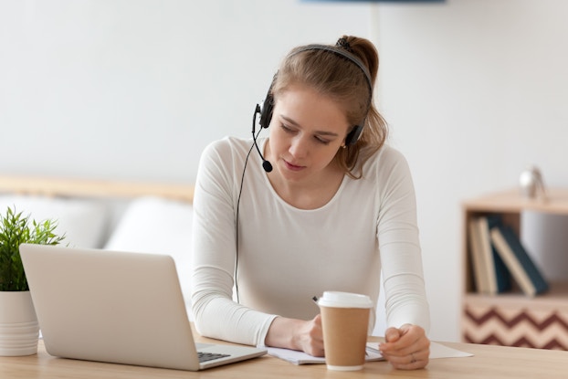 woman on laptop with headphones