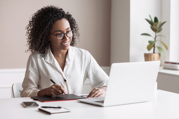 Woman working on laptop.