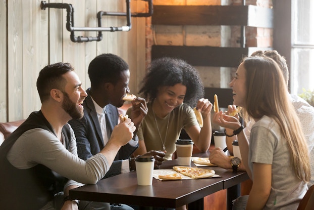 group of millennials sitting at coffee shop