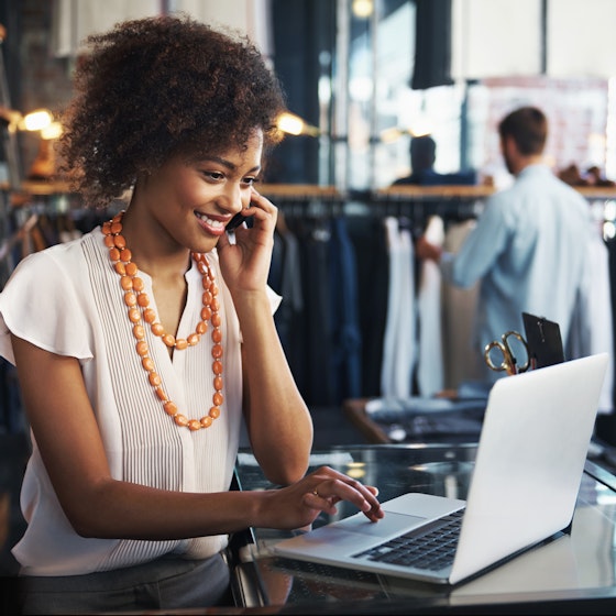 woman working in store on laptop