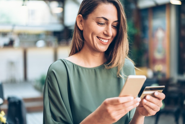  woman shopping on phone with credit card