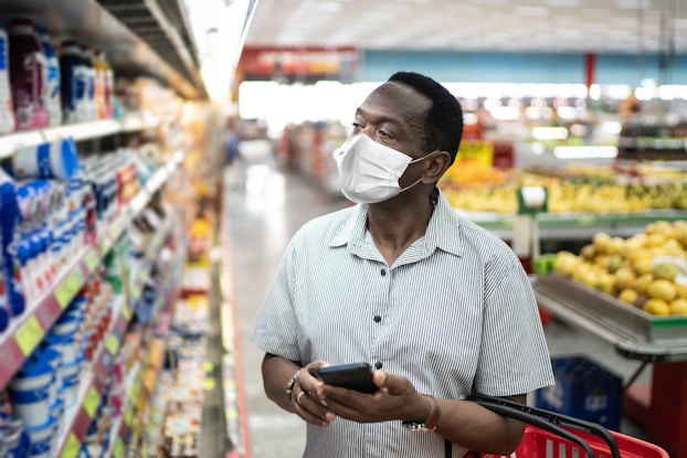  man shopping in supermarket with mask on