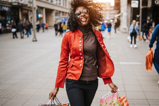 Happy woman holding shopping bags.