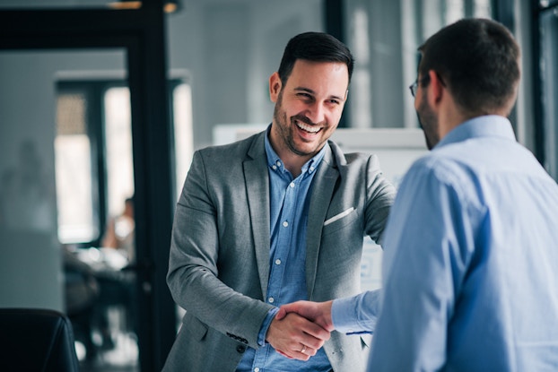 two men shaking hands at work