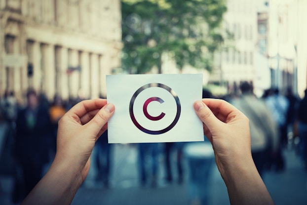 person holding copyright symbol
