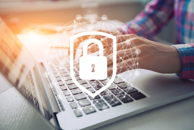 man on laptop with security icon
