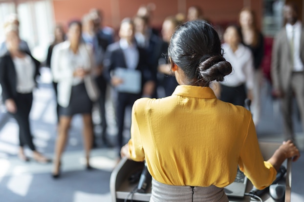 woman speaking to team of colleagues