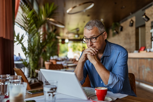 male business owner sitting at table