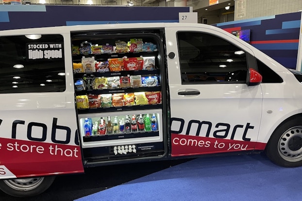  The Robomart "store-hailing" van with the door open showing a snack display.