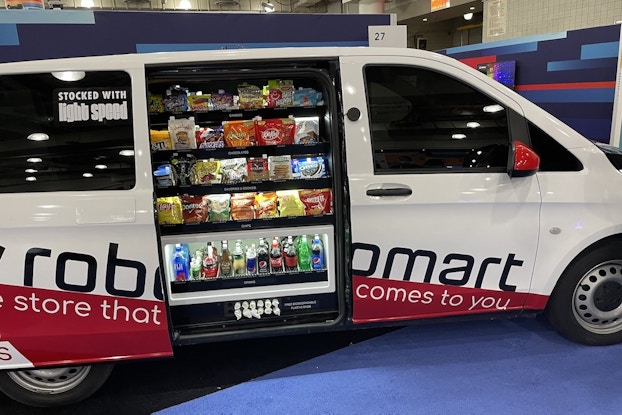 The Robomart "store-hailing" van with the door open showing a snack display.