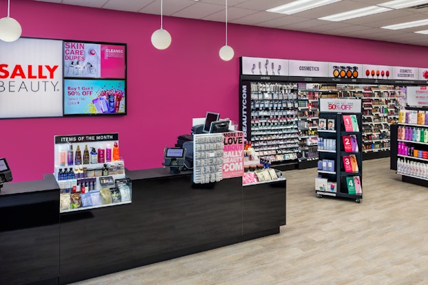  Interior of a Sally Beauty store location with hot pink walls.
