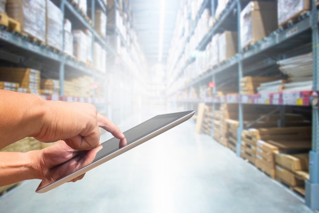 hand using ipad in stock room