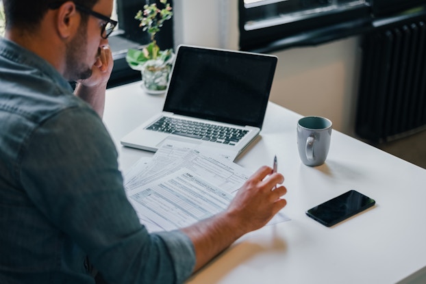 man going over paperwork at desk