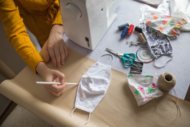 person sewing face masks