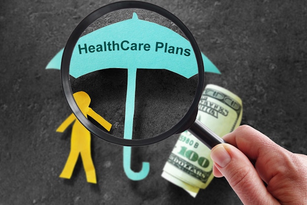 paper cutout of person and umbrella about cost of health care