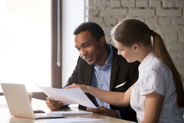  man and woman going over paperwork