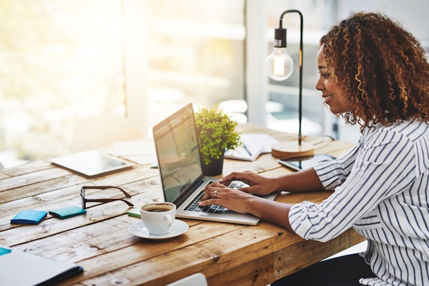  woman sitting at desk on laptop