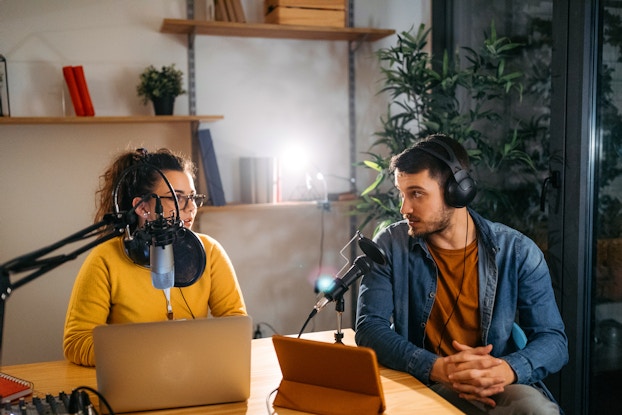 two people recording a podcast