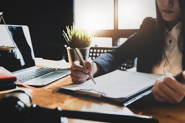  woman sitting at desk doing paperwork