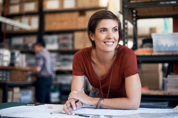  woman smiling over paperwork