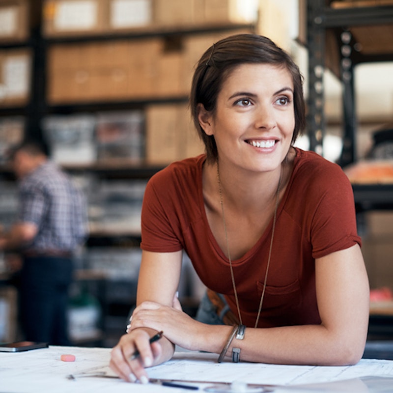 woman smiling over paperwork