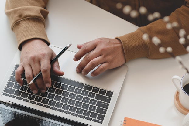  person's hands working on laptop