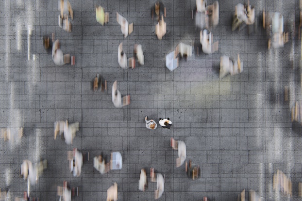  businesspeople standing in a busy street of commuters