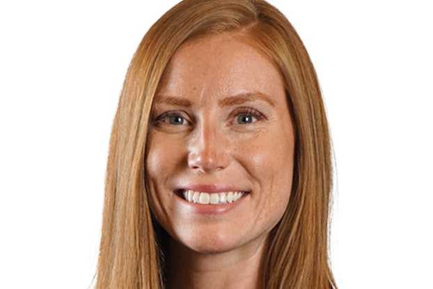 A headshot of Stephanie Johnson, a smiling white woman with long strawberry blonde hair and blue-gray eyes.