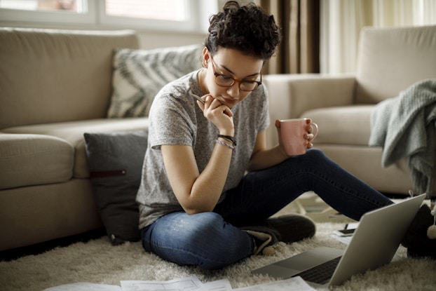 woman studying with notes and laptop