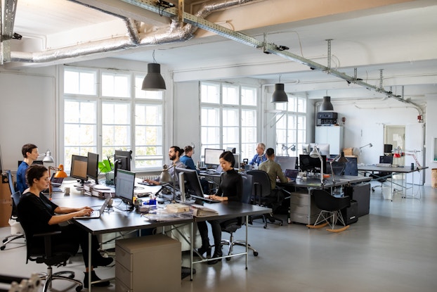 Busy modern open plan office with staff.