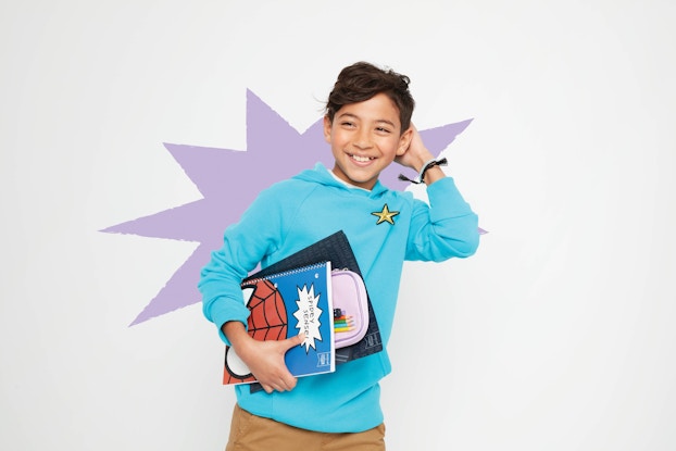  Young boy holding books in a Target back-to-school ad.