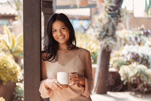  Sashee Chandran, founder and CEO, Tea Drops, holding a teacup.