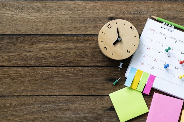  clock and calendar displayed on a table