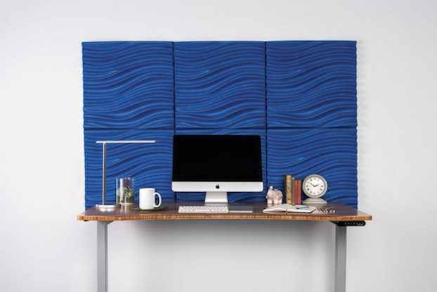  uplift desk's acoustic 3d wave wall panel behind computer desk