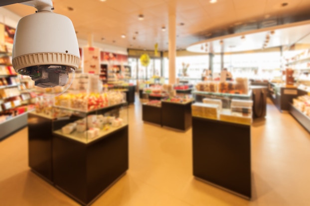 A closed-circuit video surveillance camera is installed in a shop corner to monitor the store at all times.