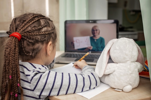  child doing schoolwork on video chat