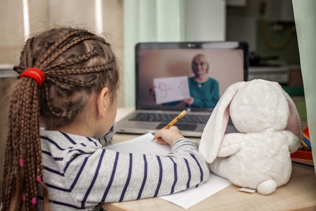 child doing schoolwork on video chat
