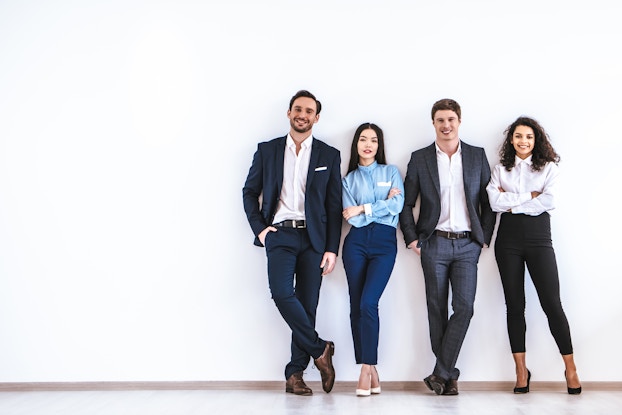 four business people standing in a row