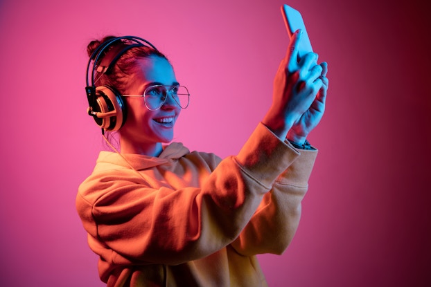 woman with headphones taking selfie