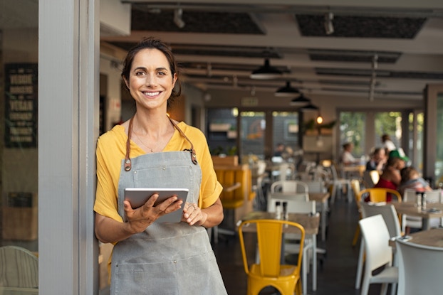  woman business owner standing in doorway