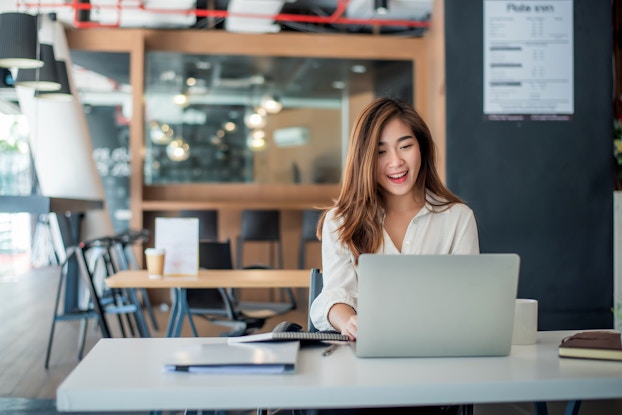 Woman sitting in an office on her laptop.
