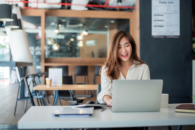  Woman sitting in an office on her laptop.