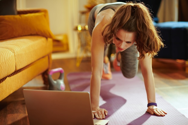  woman exercising at home virtually