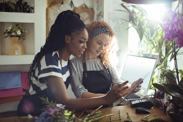  two women working in a flower shop