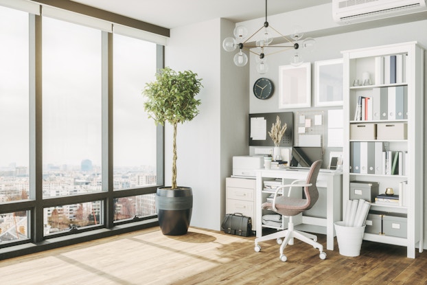 Home office in an apartment with floor-to-ceiling windows.