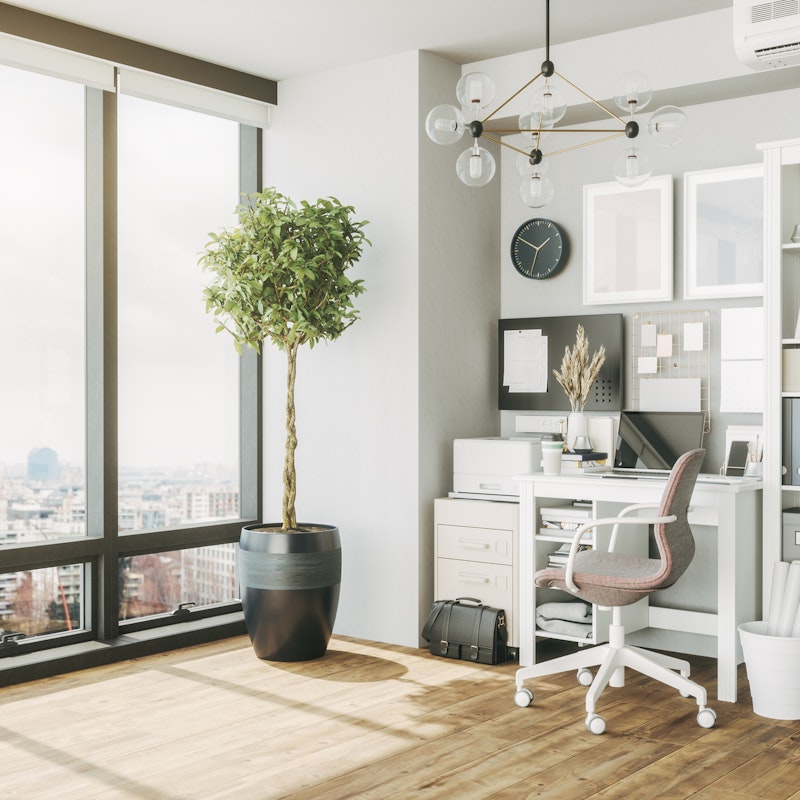 Home office in an apartment with floor-to-ceiling windows.