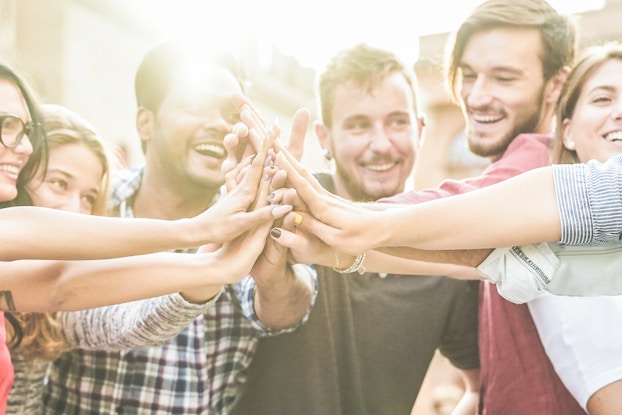  group of young professionals high-fiving