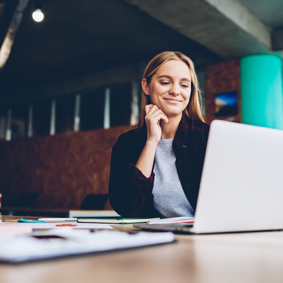 woman smiling at laptop